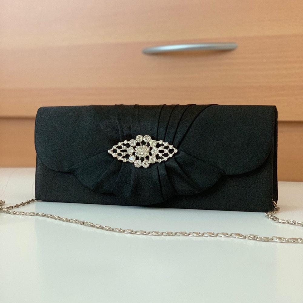 Black silk purse with rhinestones and snaps close.